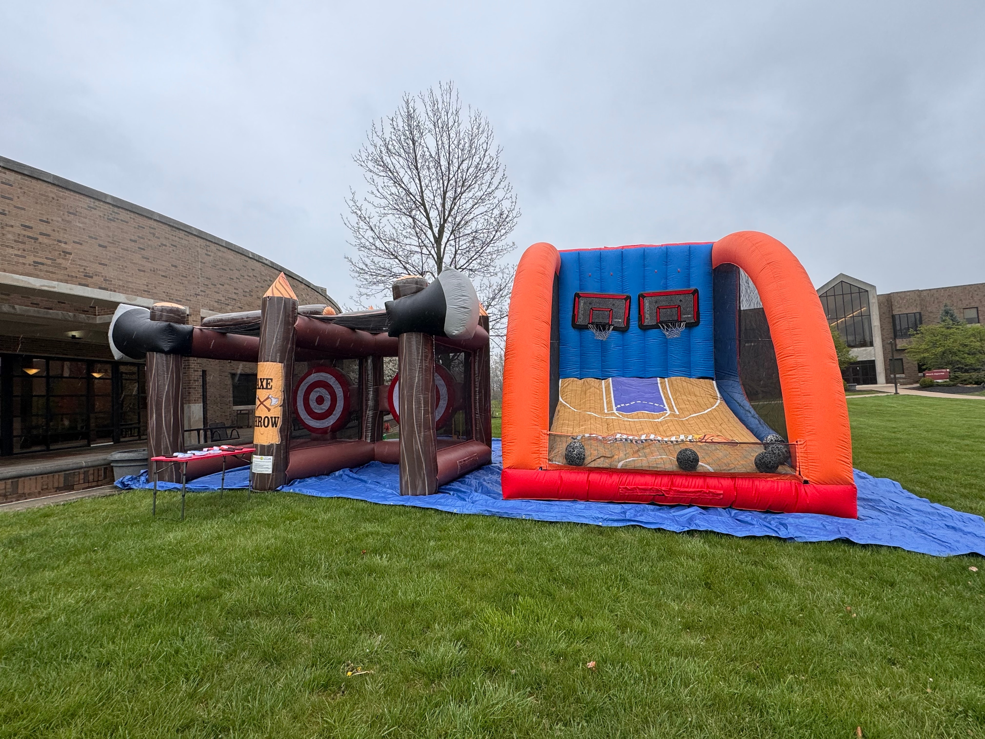Inflatable axe throwing and basketball shootout side by side