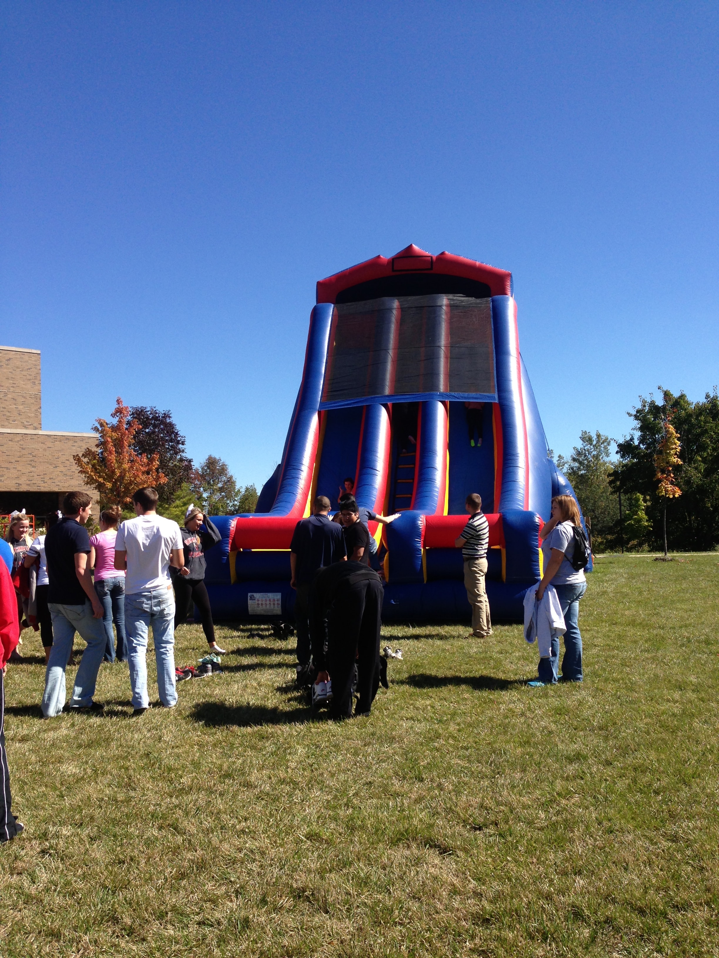 Bounce house with a crowd of guests at an outdoor event