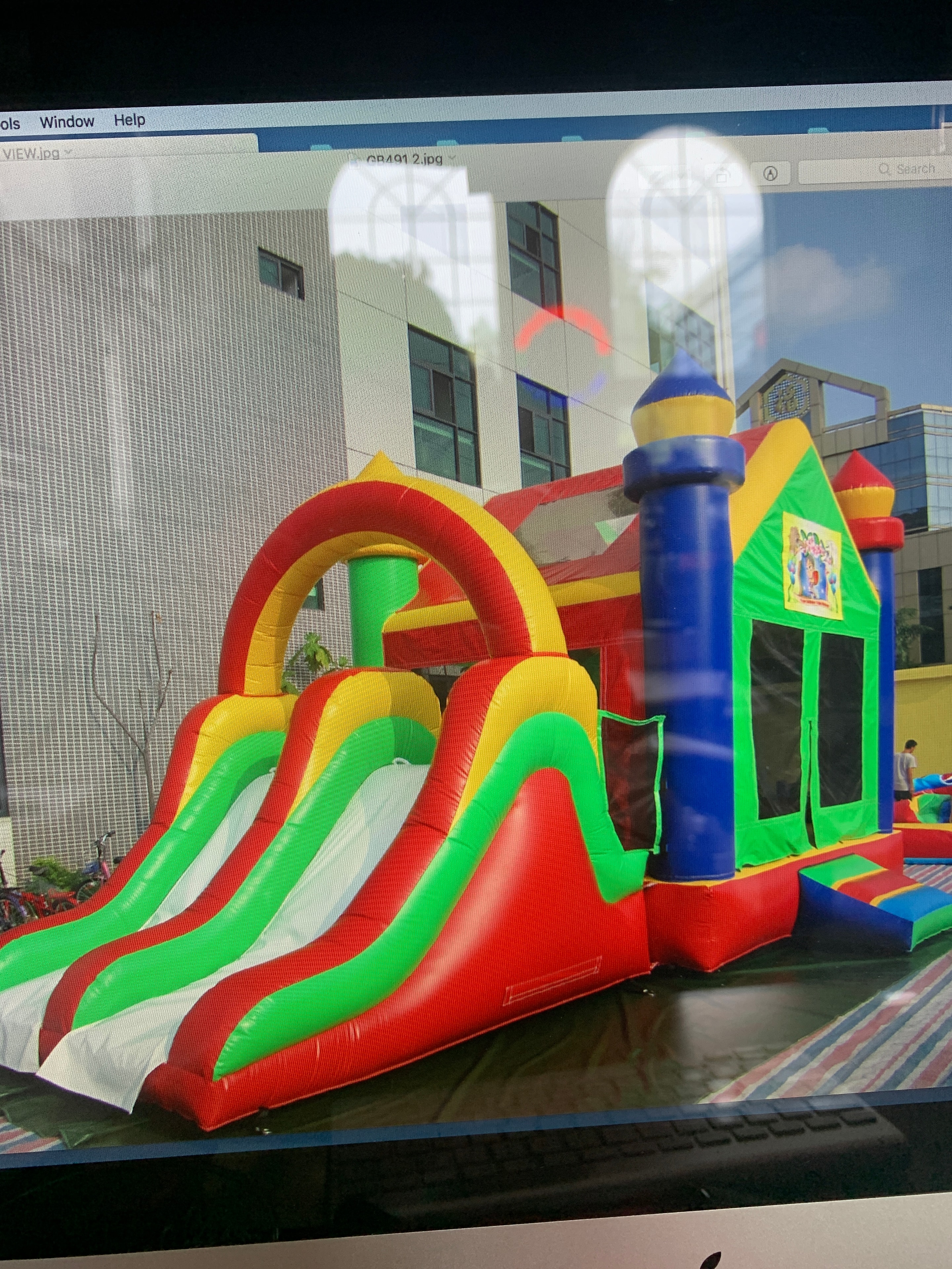 Colorful inflatable bounce house obstacle course at an outdoor event