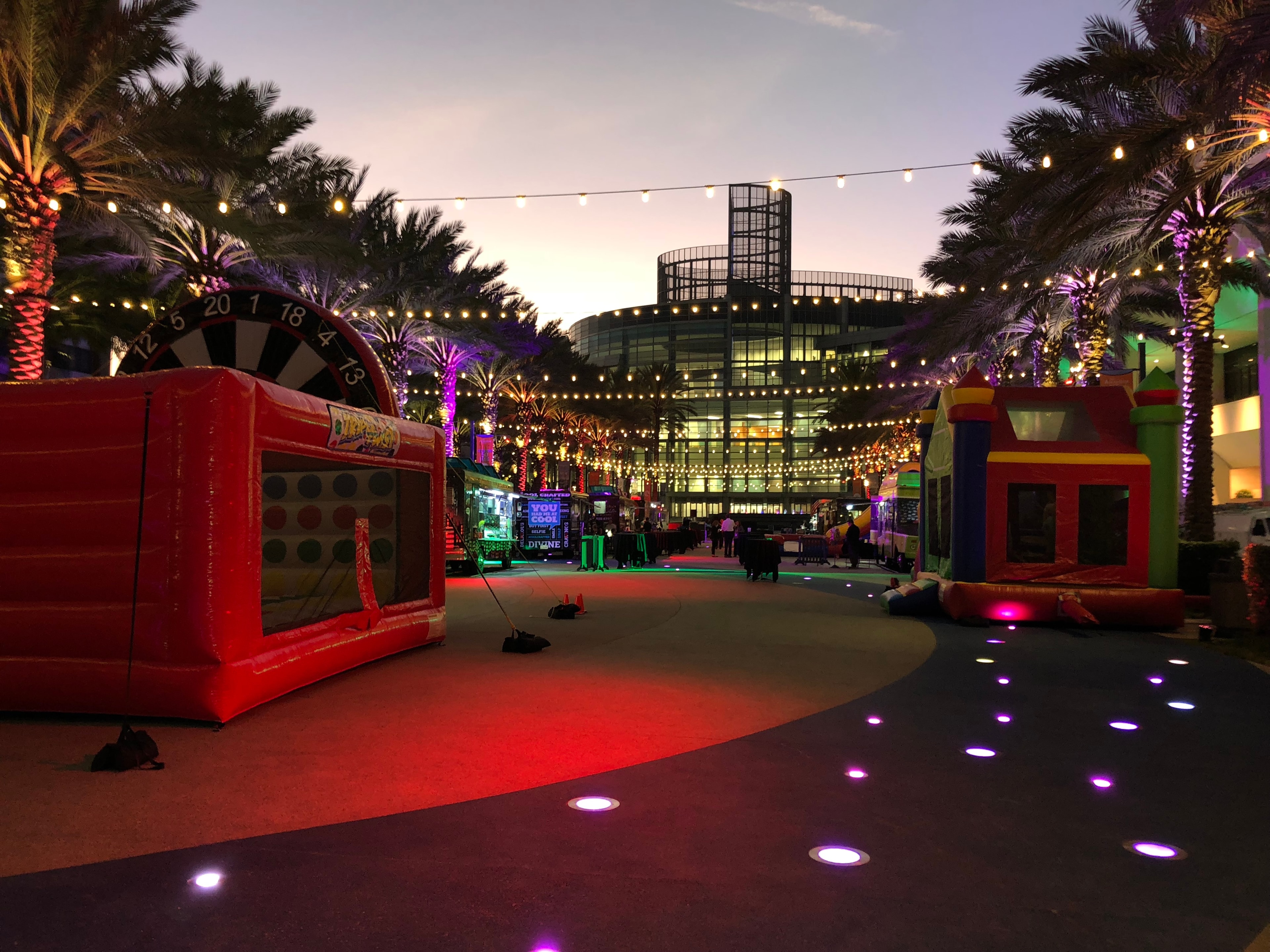 Colorful inflatable attractions lit up at a nighttime event venue