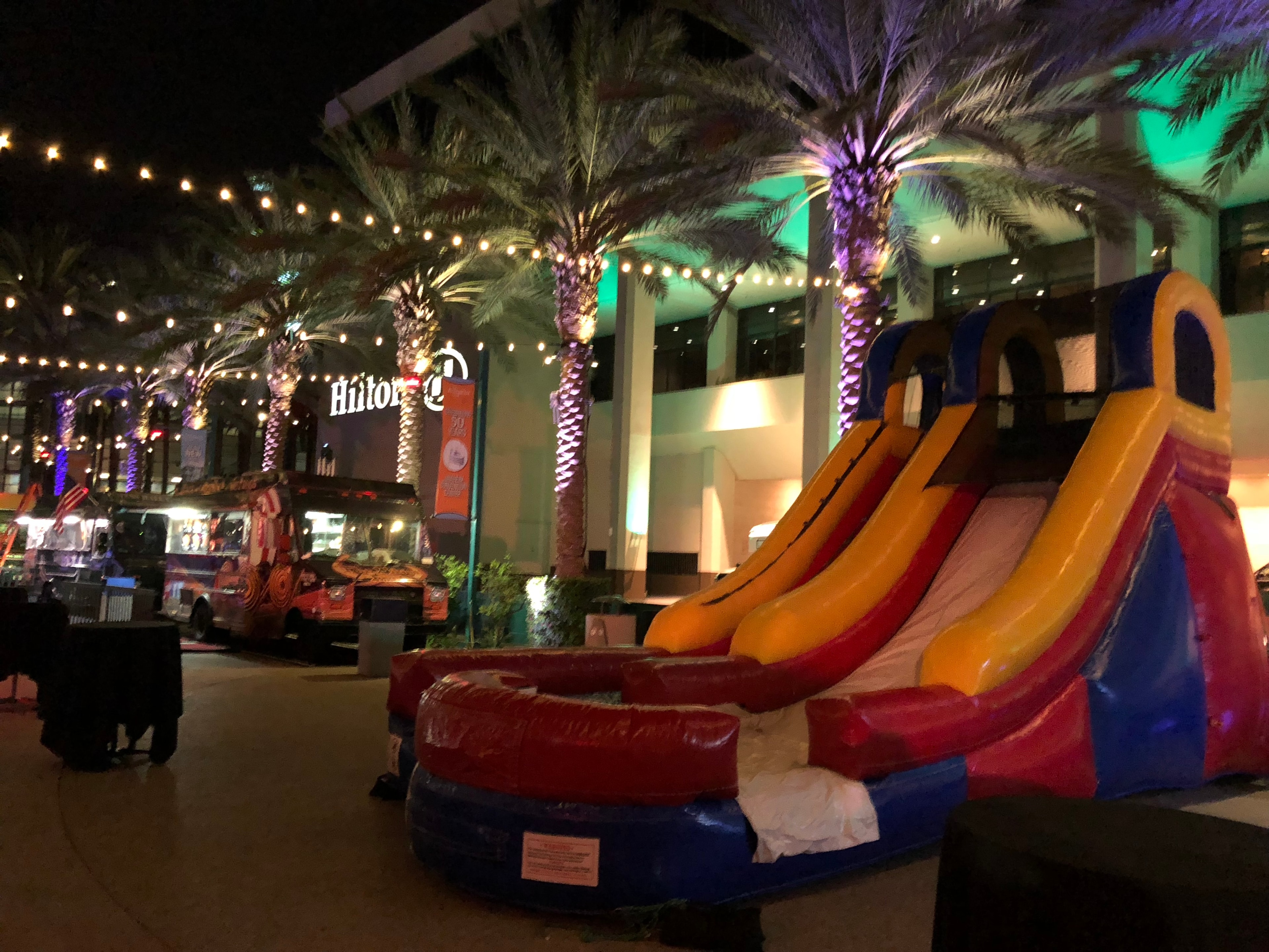 Inflatable slide glowing at a nighttime outdoor event